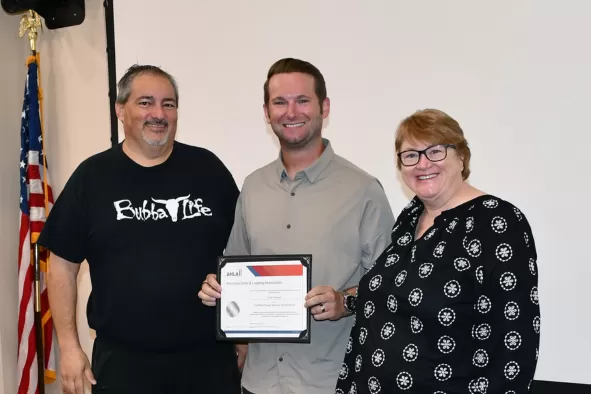 Guests First graduate smiles happily